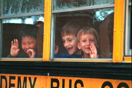 Children wave through the School Bus windows©Susan Farley Photography/NYC and Westchester PortraitBest NYC  event, Portrait and Corporate freelance photographerPhotographer. 